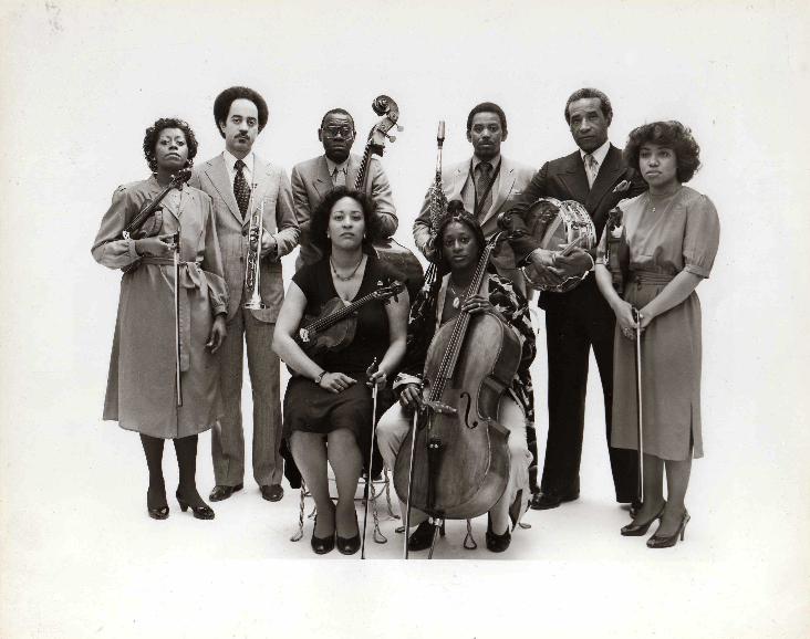 Max Roach Double Quartet, 1983:  (clockwise from left)  Gayle Dixon (violin 1), Cecil Bridgewater (trumpet), Calvin Hill (bass), Odean Pope (saxophone), Max Roach (drums), Cecelia Hobbs (violin 2), Akua Dixon (cello), Maxine Roach (viola).  Photo by Chuck Stewart